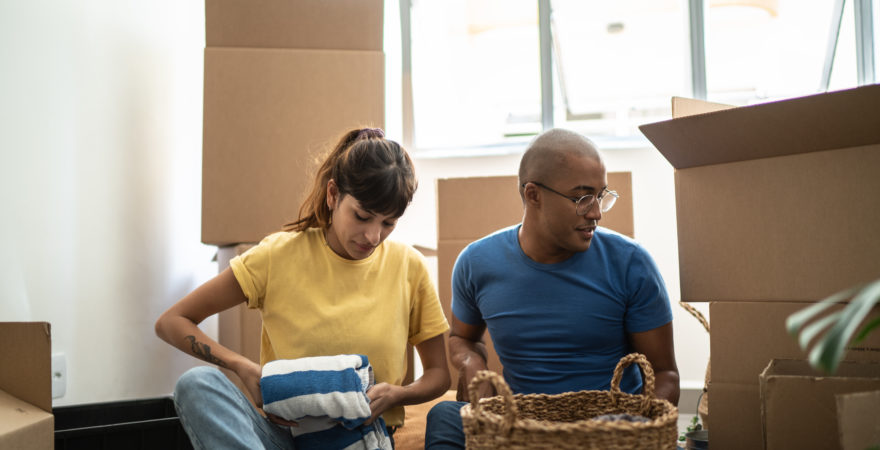 Young couple packing and moving boxes at home.
