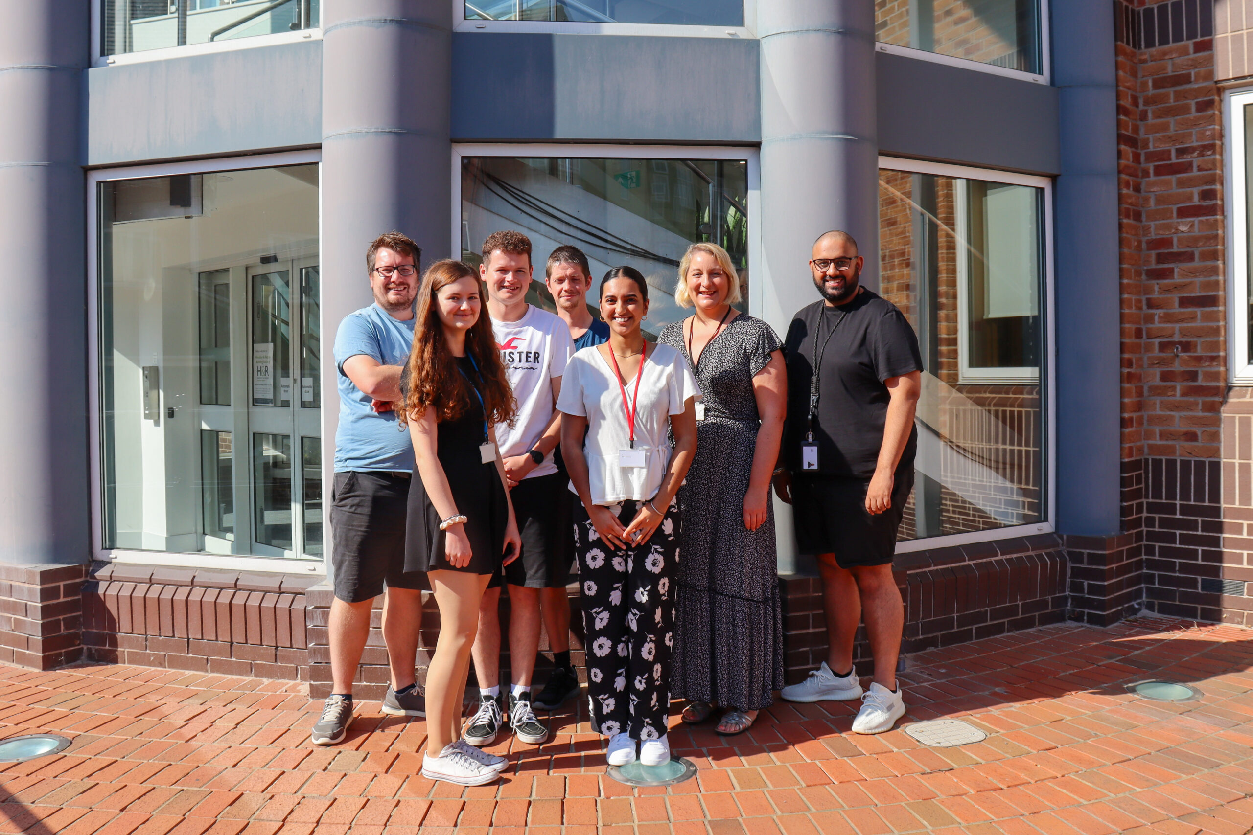 Image of Hinckley and Rugby Building Society finance team colleagues and accounting student, Monica Thiara in front of the head office in Hinckley.