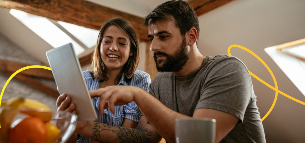 A couple looking at opening a joint savings account together by looking through paperwork.